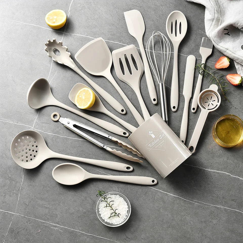 A 15-piece silicone kitchen utensil set in khaki, including spatulas, spoons, and a whisk, arranged on a light background.
