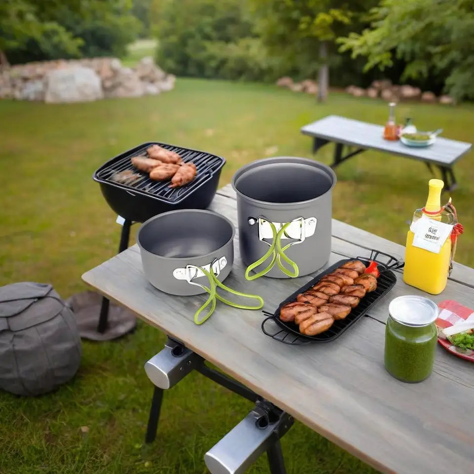 Hard aluminum alloy camping cookware set in orange and green, including pots and a frying pan, suitable for 1-2 people.