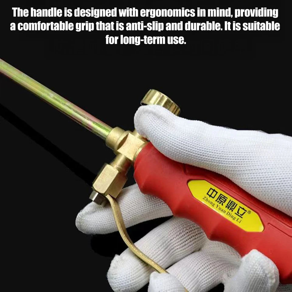 Close-up of a portable manual igniter with a gas hose attachment, shown in an outdoor setting (view 4)