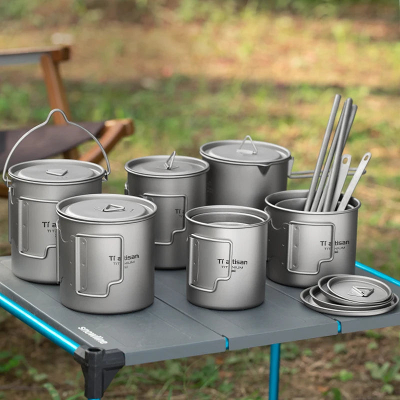 Titanium camp coffee cup with a folding handle, shown in various sizes with a mesh storage bag.