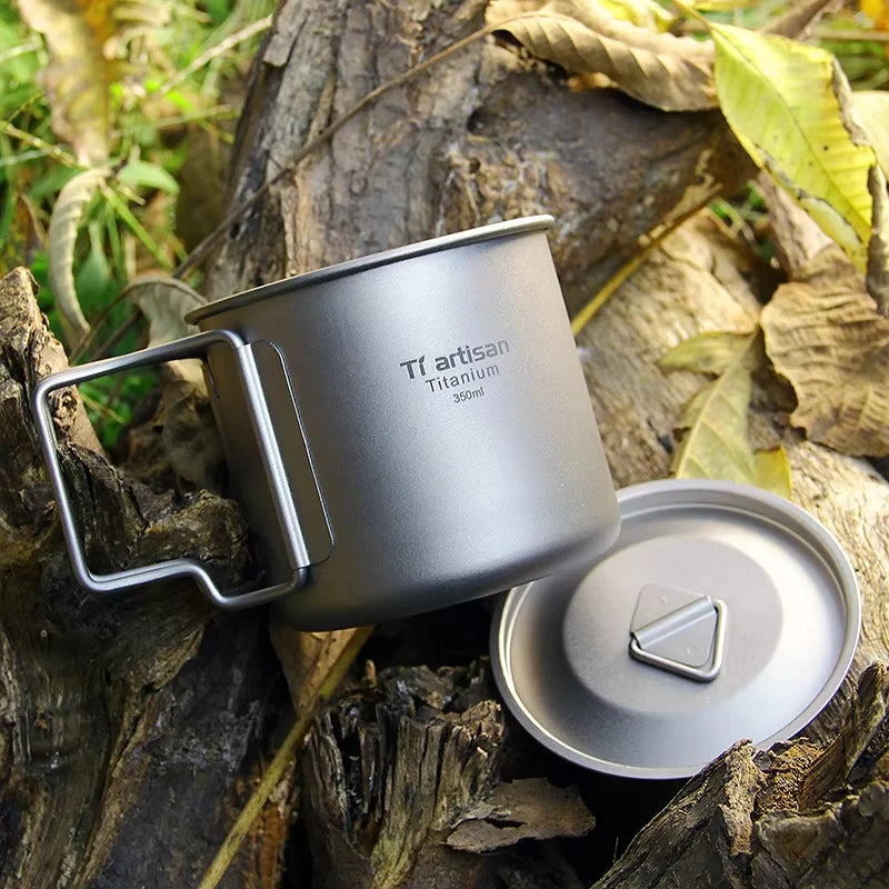Titanium camp coffee cup with a folding handle, shown in various sizes with a mesh storage bag. (view 6)
