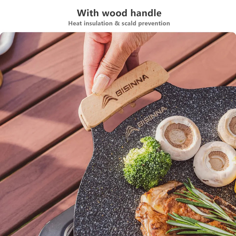 34cm round black aluminum alloy grill pan with a ridged cooking surface, shown on a camp stovetop (view 5)