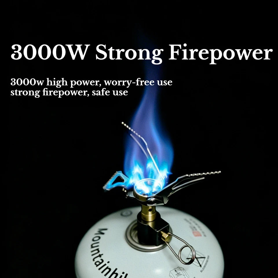 Miniature silver gas stove with an orange flame, on a dark background, showcasing its compact size (view 2)