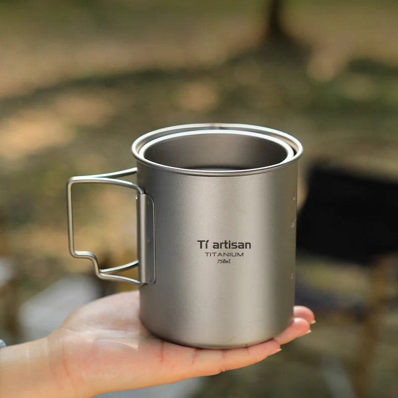 Titanium camp coffee cup with a folding handle, shown in various sizes with a mesh storage bag. (view 5)