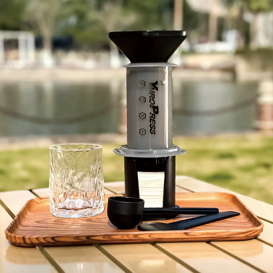 Portable press-style coffee maker in black, white, and red color options (view 2)