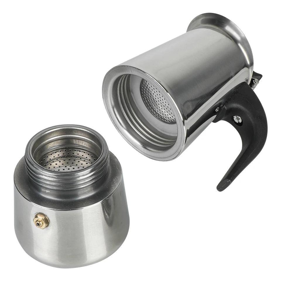 Stainless steel moka pot on a stovetop with coffee pouring into the upper chamber (view 4)