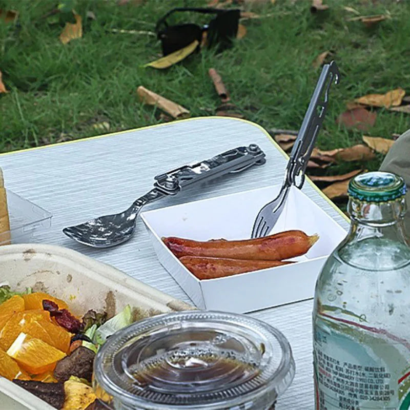 A single piece of silver stainless steel foldable cutlery, showing its compact folded form. (view 4)