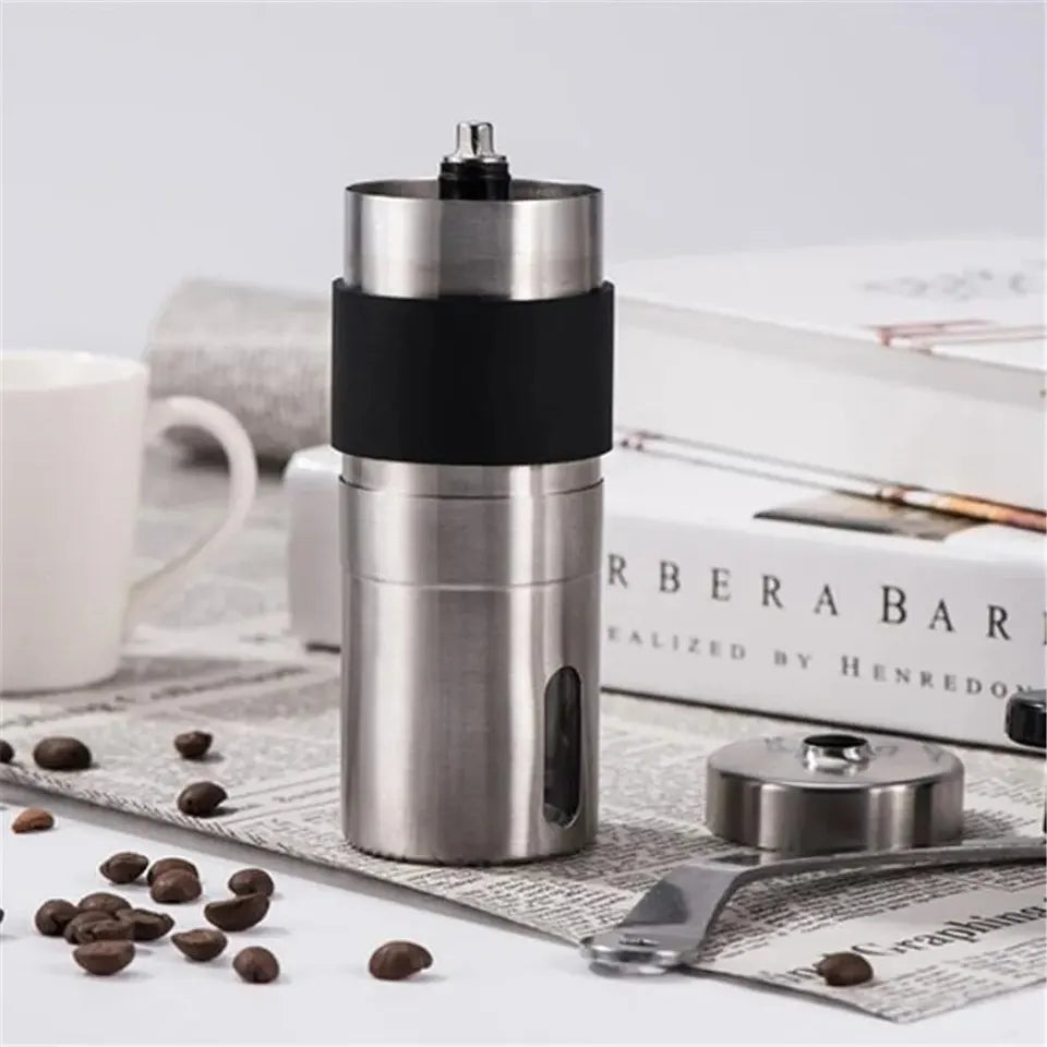Portable stainless steel manual coffee grinder with handle and clear base (view 2)