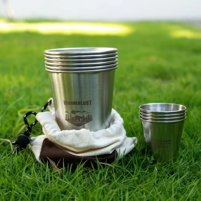 A stack of 304 stainless steel camp cups in an outdoor setting (view 2)