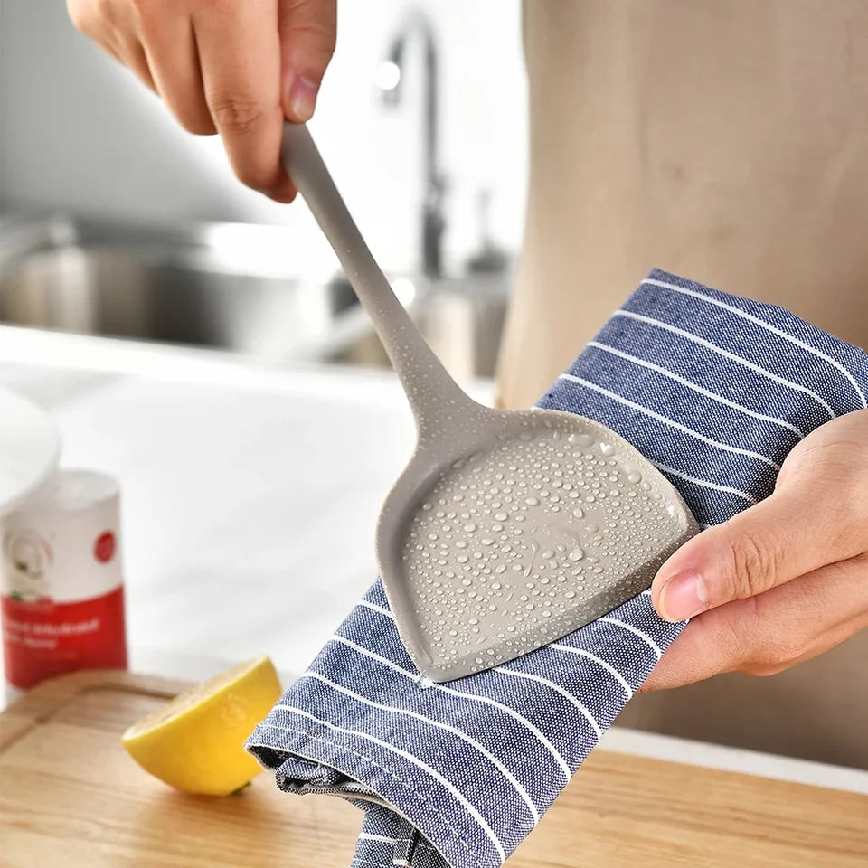 A 15-piece silicone kitchen utensil set in khaki, including spatulas, spoons, and a whisk, arranged (view 2)