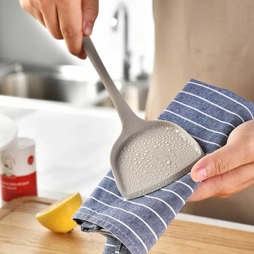 A 15-piece silicone kitchen utensil set in khaki, including spatulas, spoons, and a whisk, arranged (view 2)