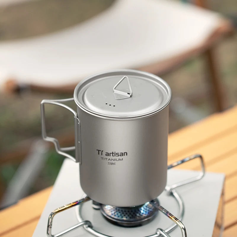 Titanium camp coffee cup with a folding handle, shown in various sizes with a mesh storage bag. (view 4)