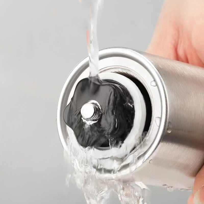Portable stainless steel manual coffee grinder with a hand crank and adjustable ceramic burrs (view 3)