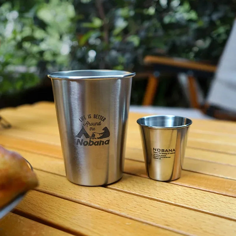 A stack of 304 stainless steel camp cups in an outdoor setting (view 3)