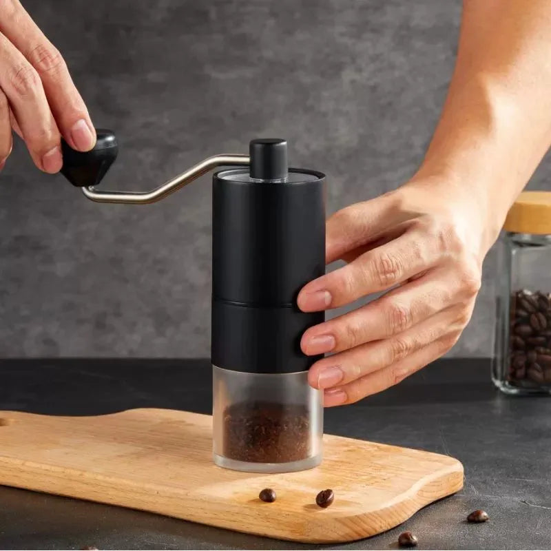 Portable hand-crank coffee grinder made of stainless steel with a black handle (view 3)