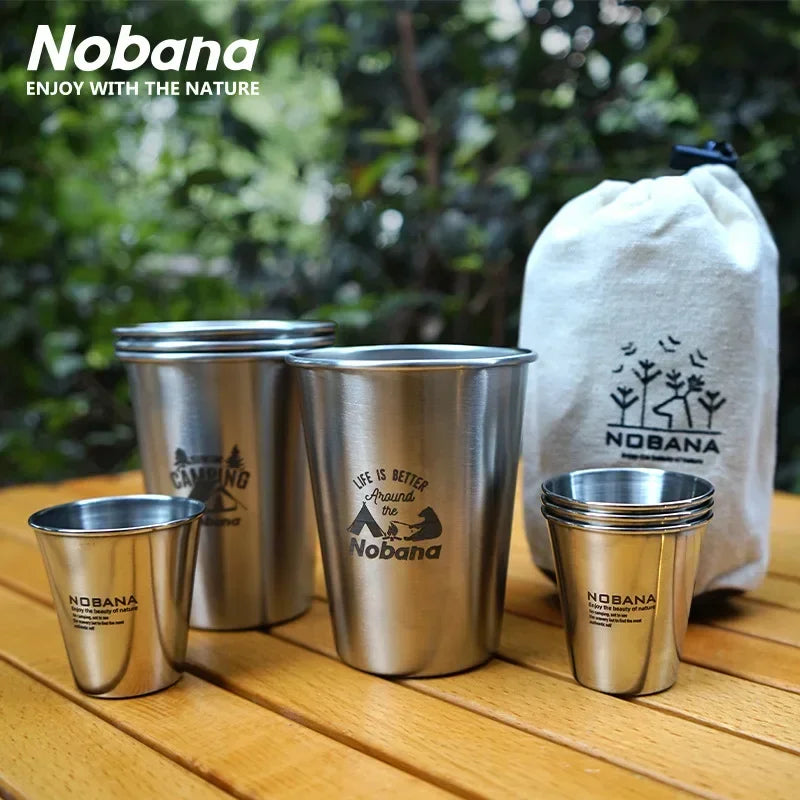 A stack of 304 stainless steel camp cups in an outdoor setting