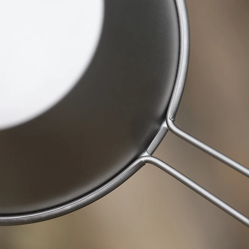 A single 260ml titanium camping bowl with a fixed handle, shown from an overhead angle. (view 6)